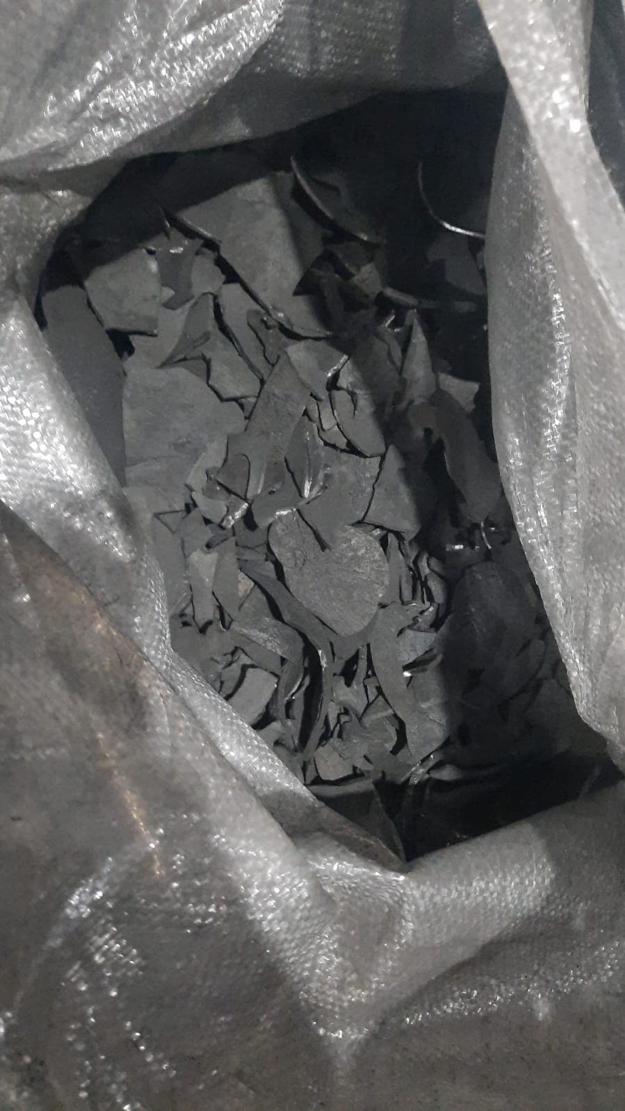 Close-up of coconut shell charcoal packed in lined export bag