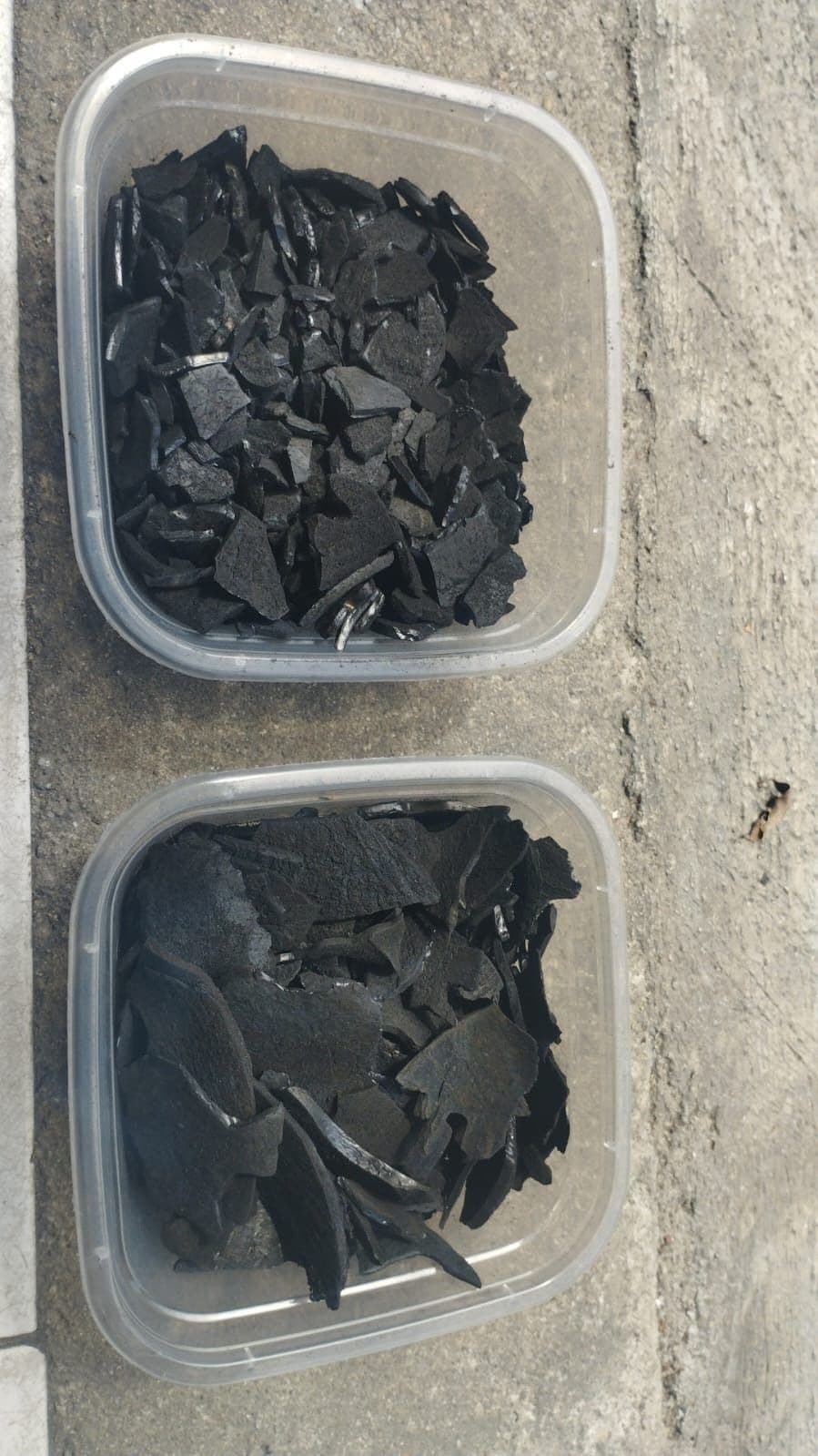 Coconut shell charcoal quality control samples in containers
