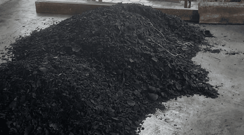 Screened granular coconut shell charcoal pile after sorting process