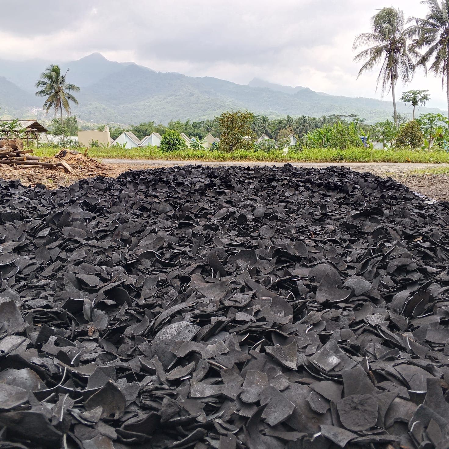 Coconut shell charcoal stockpile at Lampung production facility for export supply