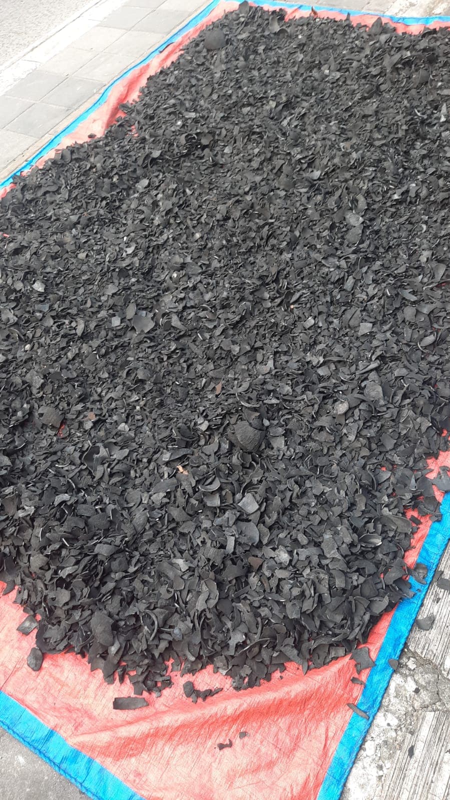 Granular coconut shell charcoal material in production sack
